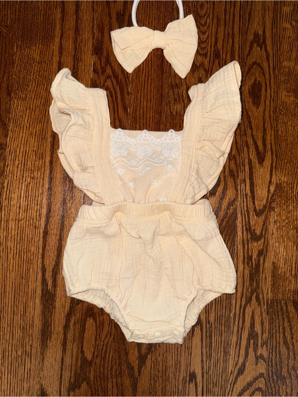 Soft Cream Ruffle Baby One-Piece with Lace Detail